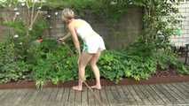 Sexy Sonja wearing a *white* shiny nylon shorts with a white top durig watering the garden (Video)