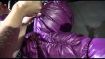 Sexy Sandra being tied and gagged overhead with ropes and a bar wearing a sexy black rain pants and a purple down jacket with hood closed (Video)