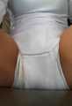 In a white onesie with Absorin diaper