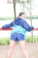 Enni wearing sexy shiny nylon shorts and rain jacket while stretching herself on a sea (Pics)