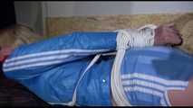 Pia wearing a sexy lightblue shiny nylon shorts and a lightblue rain jacket being tied and gagged with ropes on her bed (Video)