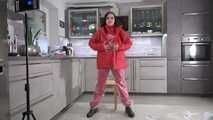 Miss Amira in red nylon rain gear and tranparent rain suit