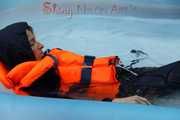 Watching sexy Sonja wearing a sexy shiny nylon rain pant and rain jacket as well as a lifevest enjoying the water in the swimming pool (Pics)