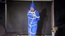 Pia being tied and gagged overhead with ropes and a ballgag wearing sexy shiny nylon rainwear (Video)