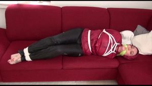 Jill tied, gagged and hooded on a sofa wearing sexy shiny black rain pants and an oldschool red rain jacket (Video)