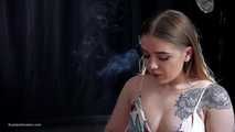 Tattooed girl is smoking a marlboro red