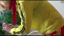 Pia tied and gagged on a stairway with cuffs wearing a sexy red/yellow shiny nylon shorts and a yellow rain jacket (Video)