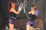 Watching sexy Stella and Sandra both wearing a hot shiny nylon shorts and a top being tied and gagged overhead with ropes and a ballgag (Pics)