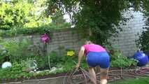 Watch Maly in her shiny nylon Shorts enjoying the warm Weather in the Garden