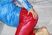 Watching sexy Sandra putting on a very special red shiny nylon pant posing and lolling for you (Pics)