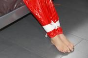 Samantha tied and gagged on bed wearing a shiny red PVC sauna suit (Pics)