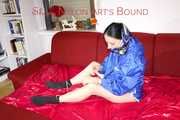 Lucy ties and gagges herself on a sofa wearing sexy blue shiny nylon shorts and rain jacket (Pics)