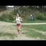 Enni jogs wearing red shiny nylon shorts and a top (Video)