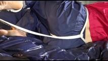 Sonja tied and gagged on bed with cuffs wearing a sexy rainwear combination (Video)