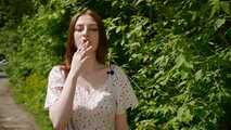 18 y.o. Sasha is smoking two white 120mm cigarettes outdoors