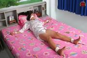 Asian Girl is Tied Spread on the Bed