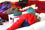 Mara tied and gagged on a sofa wearing a sexy blue shiny nylon shorts and a red/blue Rain jacket (Pics)