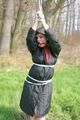 Jill tied, gagged and hooded on a tree outdoor wearing a shiny black down jacket (Pics)