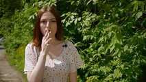 18 y.o. Sasha is smoking two white 120mm cigarettes outdoors