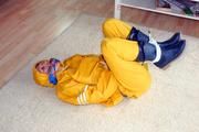 Katharina tied and gagged in a yellow rainsuit