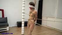 Naked girl tied up between tow stakes