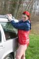 Jill tied and gagged outdoor on a car wearing a sexy red shiny nylon shorts and an oldschool rain jacket (Pics)