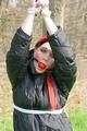 Jill tied, gagged and hooded on a tree outdoor wearing a shiny black down jacket (Pics)