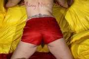 Watching Mara wearing ONLY a hot red shiny nylon shorts posing and lolling on a sofa (Pics)