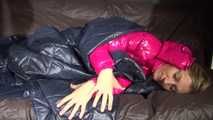 Watching sexy Sandra wearing a sexy pink shiny nlon rain pants and a shiny nylon pink down jacket nestle down in a down cover (Video)