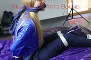Samantha tied and gagged on bed wearing a shiny darkblue nylon rain pants and a light blue rain jacket (Pics)