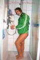 Stella tied and gagged in a shower wearing a white shiny nylon shorts and a green rain jacket (Pics)