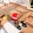 Stella lolling on a table wearing a sexy red shiny nylon adidas shorts and a bikini (Pics)