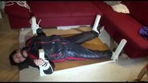 Mara tied and gagged on a bottom-up table wearing a supersexy black/red downwear combination (Video)