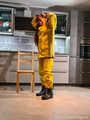Miss Lara in nylon rain suit and yellow rain dungarees is bound and gagged