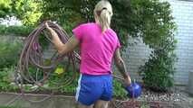 Watch Maly in her shiny nylon Shorts enjoying the warm Weather in the Garden