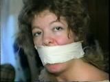 25 YR OLD CHARLENE IS WRAP GAGGED & CHAIR TIED TO A CHAIR WITH WHITE CLOTH MEDICAL TAPE (D47-14)
