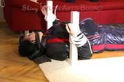 Mara tied and gagged on a bottom-up table wearing a supersexy black/red downwear combination (Pics)