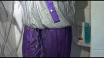 Mara wearing a sexy purple/silver pvc combination tied and gagged on a shower (Video)