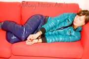 SEXY ALINA playing with cuffs wearing a hot blue shiny nylon down pants and a green down jacket lolling on the sofa (Pics)