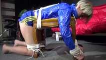 Watching sexy Sonja wearing a sexy shiny nylon shorts in blue and a blue rain jacket being tied and gagged on a stool with ropes and a clothgag (Video)