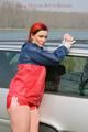 Jill tied and gagged outdoor on a car wearing a sexy red shiny nylon shorts and an oldschool rain jacket (Pics)