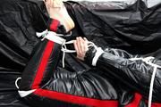 Jill bound and gagged in a shiny nylon skisuit