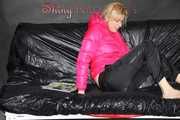 Watching sexy Pia wearing  a sexy black shiny nylon rain pants and a pink down jacket enjoying herself and lolling on the sofa (Pics)