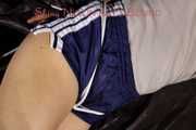 Sexy Sandra being tied and gagged with ropes and a cloth gag on a sofa wearing a sexy blue shiny nylon shorts and a grey tshirt (Pics)