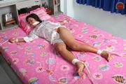 Asian Girl is Tied Spread on the Bed