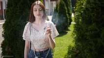 18 y.o. Sasha is smoking two white 120mm cigarettes outdoors