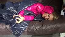 Watching sexy Sandra wearing a sexy pink shiny nlon rain pants and a shiny nylon pink down jacket nestle down in a down cover (Video)