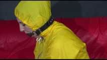 ***MARA*** ties and gagges with cuffs on the sofa wearing a supersexy oldschool yellow rain suit with hood (Video)