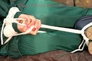 Pia tied, gagged and hooded in a princess bed wearing sexy shiny green rainwear (Pics)