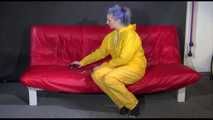 ***MARA*** ties and gagges with cuffs on the sofa wearing a supersexy oldschool yellow rain suit with hood (Video)